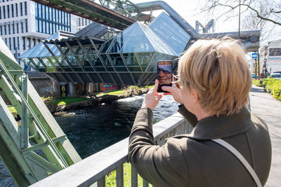 Middle-aged woman making a report of the wuppertal suspension railway train