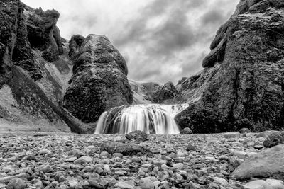 Scenic view of waterfall against sky