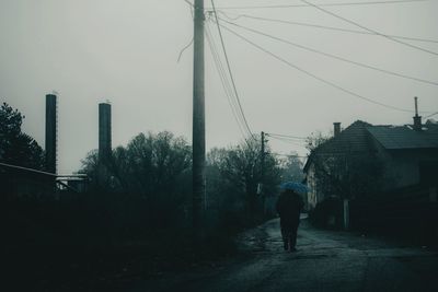 Rear view of man walking on street