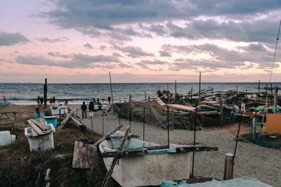 Boats moored in marina at sunset