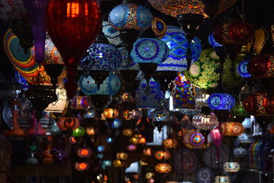 Illuminated lanterns hanging for sale in store