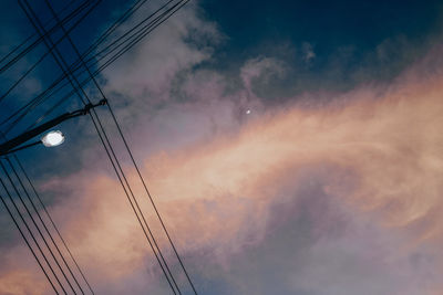 Low angle view of electricity pylon against sky