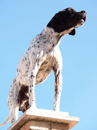 Low angle view of statue against clear blue sky