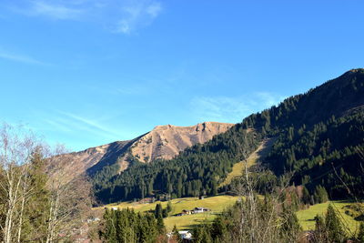 Scenic view of mountains against blue sky