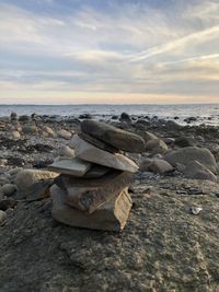 Rocks on beach against sky