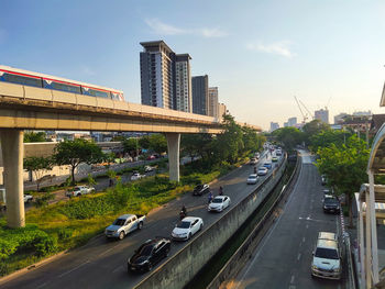 Vehicles on highway against sky