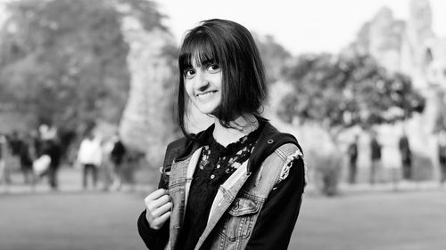 Portrait of smiling young woman standing outdoors