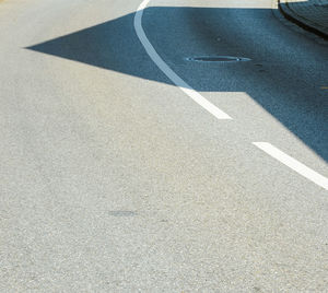 High angle view of arrow symbol on road