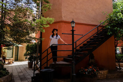 Portrait of young man standing on staircase