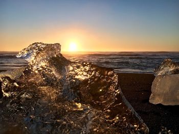 Scenic view of sea against clear sky during sunset