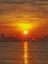 Scenic view of sea against romantic sky at sunset