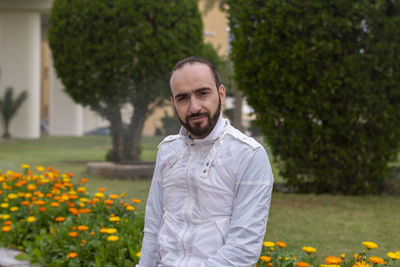 Portrait of smiling man standing against plants