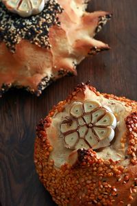 Close-up of slice garlic on bread at table