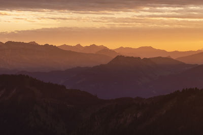 Scenic view of silhouette mountains against sky during sunset