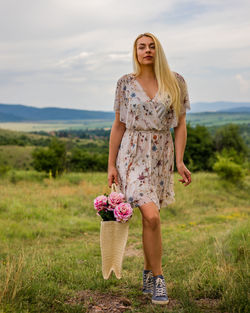 Young woman standing on field