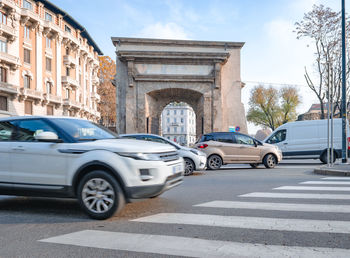 Cars on street against buildings in city