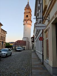 Street amidst buildings against sky in city