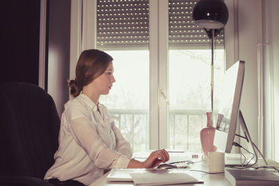 Businesswoman working on table in office