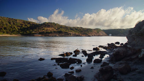 Scenic view of river and mountains against sky