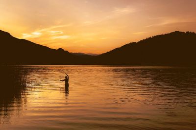 Scenic view of lake against sky during sunset