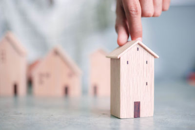 Close-up of hand holding paper house