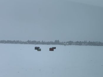 Scenic view of lake against clear sky during winter