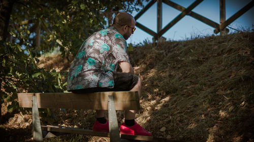 Full length of young woman standing on bench