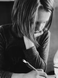 Close-up of girl writing in book