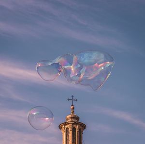 Low angle view of bubbles against sky