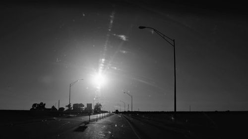 Cars on highway in city against sky