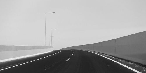Empty highway against clear sky