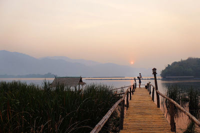 Scenic view of pier against sky during sunset