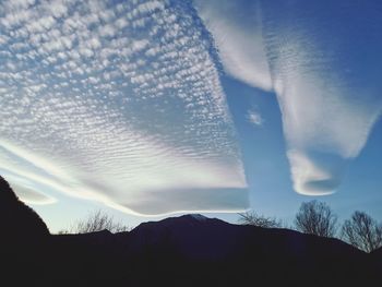 Scenic view of silhouette mountain against sky during winter