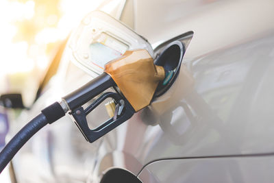 Close-up of pump filling fuel in car