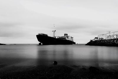 Boat in calm sea against the sky