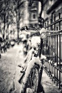 Close-up of bicycle parked against blurred background
