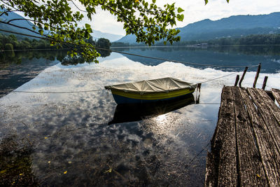 Blue and yellow wooden boat covered with a tarp in revine lago treviso veneto italy