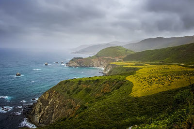 Scenic view of sea and mountains against sky