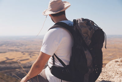 Midsection of man wearing hat while standing on land