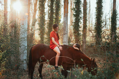 Young woman riding horse