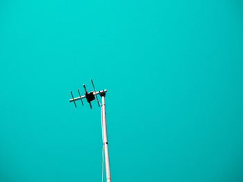 Low angle view of floodlight against blue sky