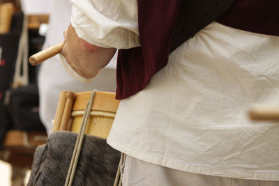 Rear view of man holding umbrella