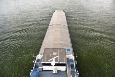 A barge carrying coal with a covered hold on the river rhine. transport of coal and solid fuel