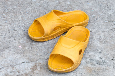 High angle view of yellow shoes on street