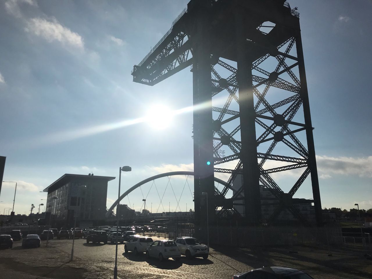 LOW ANGLE VIEW OF BRIDGE OVER CITY AGAINST SKY