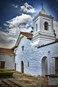 Low angle view of church against cloudy sky