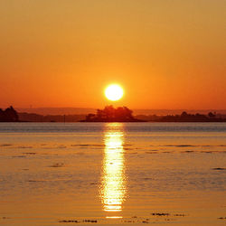 Scenic view of sea against romantic sky at sunset