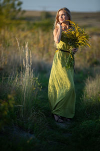 Young woman standing on field