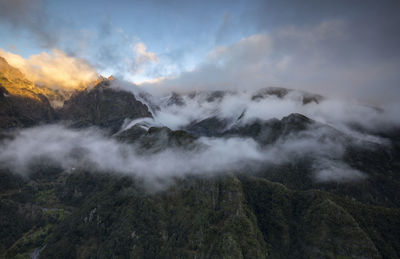 Scenic view of mountains against cloudy sky