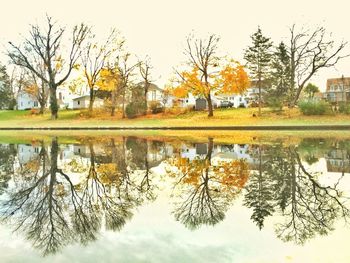 Reflection of trees in lake against sky